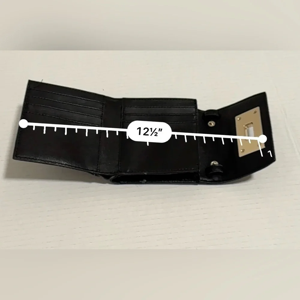 Calvin Klein black trifold wallet with a gold-tone metal closure